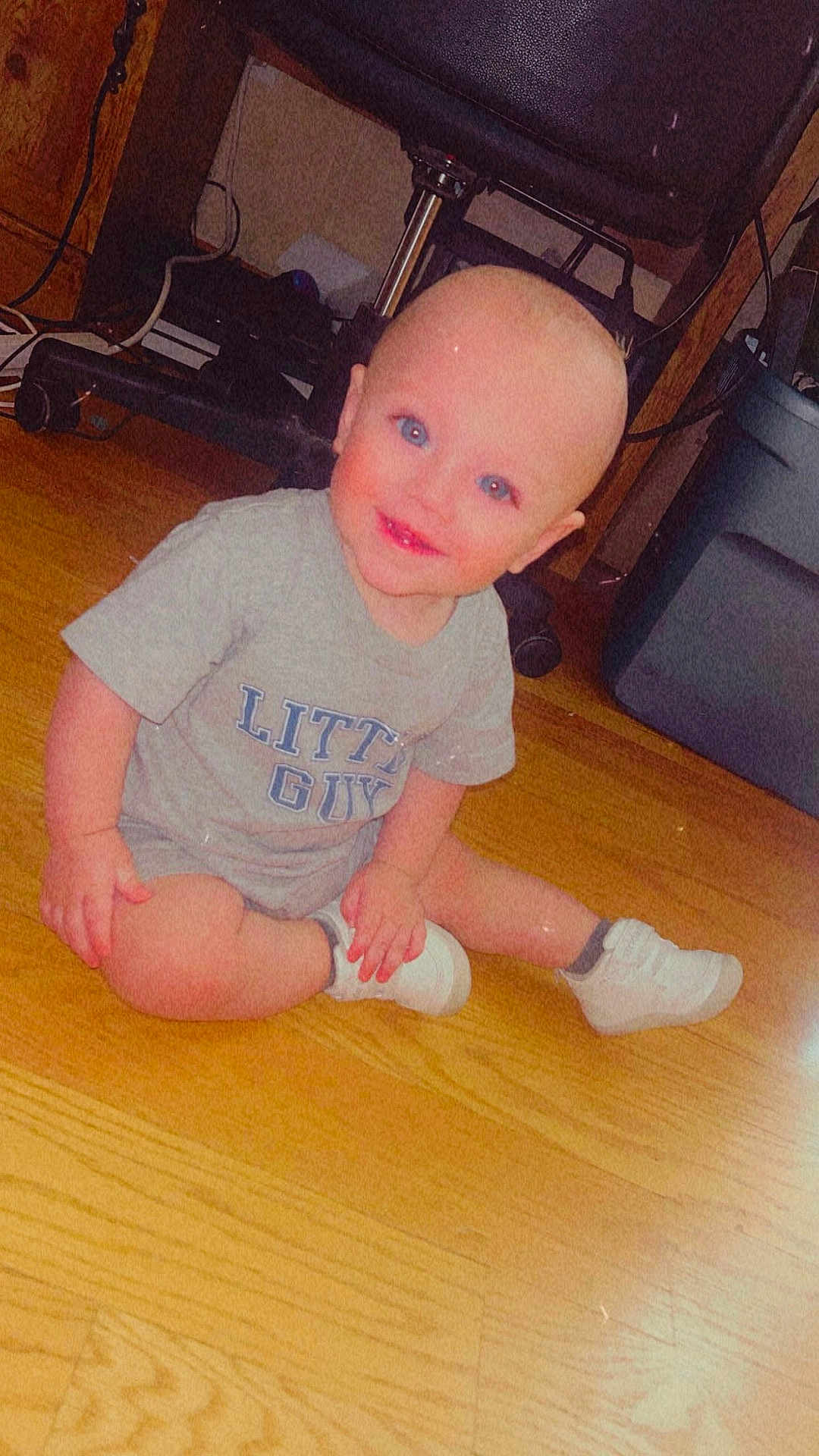 Anakyn joined the competition — help win amazing prizes! baby, child, toddler, sitting, blue_eyes, bald_head, grey_tshirt, white_shoes, wooden_floor, indoors, smiling, happy, person, floor, cable, office_chair, storage_bin, furniture, casual_clothing, cute