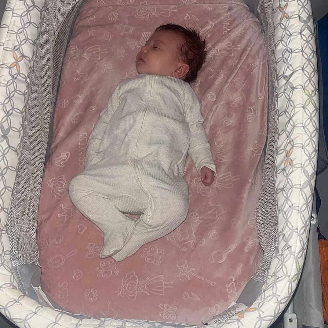 Vidalia joined the competition — help win amazing prizes! newborn, baby, sleeping, bassinet, crib, infant, portrait, indoors, pink_blanket, onesie, baby_gear, nursery, resting, curled_up, peaceful, face, hair, bedding, furniture, photography