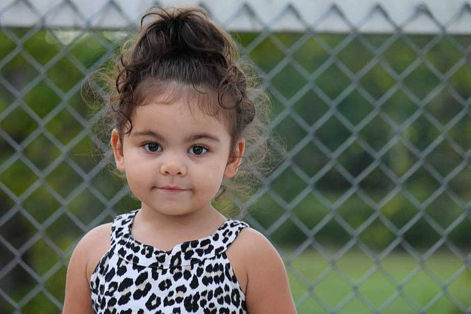 Harleigh joined the competition — help win amazing prizes! baby_toddler_clothing, beauty, brown_hair, chain_link_fencing, child, child_model, day_dress, eyelash, fence, hairstyle, iris, joy, lip, mesh, pattern, person, portrait_photography, skin, sleeveless_shirt, summer