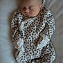 baby, newborn, sleeping, infant, onesie, leopard_print, mittens, soft, blanket, cozy, clothing, peaceful, face, head, person, cute, resting, indoor, child, portrait