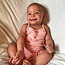 baby, barefoot, child, cozy, cute, face, hand, happy, head, indoors, infant, light, pink_clothing, portrait, romper, sitting, skin, smiling, soft_blanket, toe
