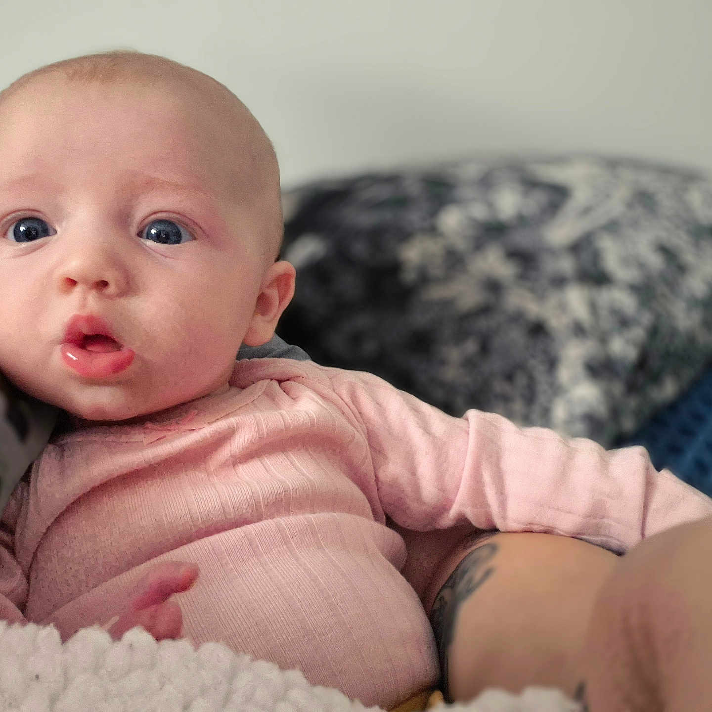 Lydia Bree is registered to the contest to win money with this photo: baby, blanket, child, comfort, cozy, cute, expression, eyes, face, hand, indoors, infant, mouth, person, pink_clothing, portrait, resting, skin, soft_light, young