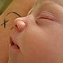 baby, sleeping, close_up, face, profile, skin, peaceful, infant, child, tattoo, arm, resting, soft, young, portrait, human, cute, calm, nose, mouth