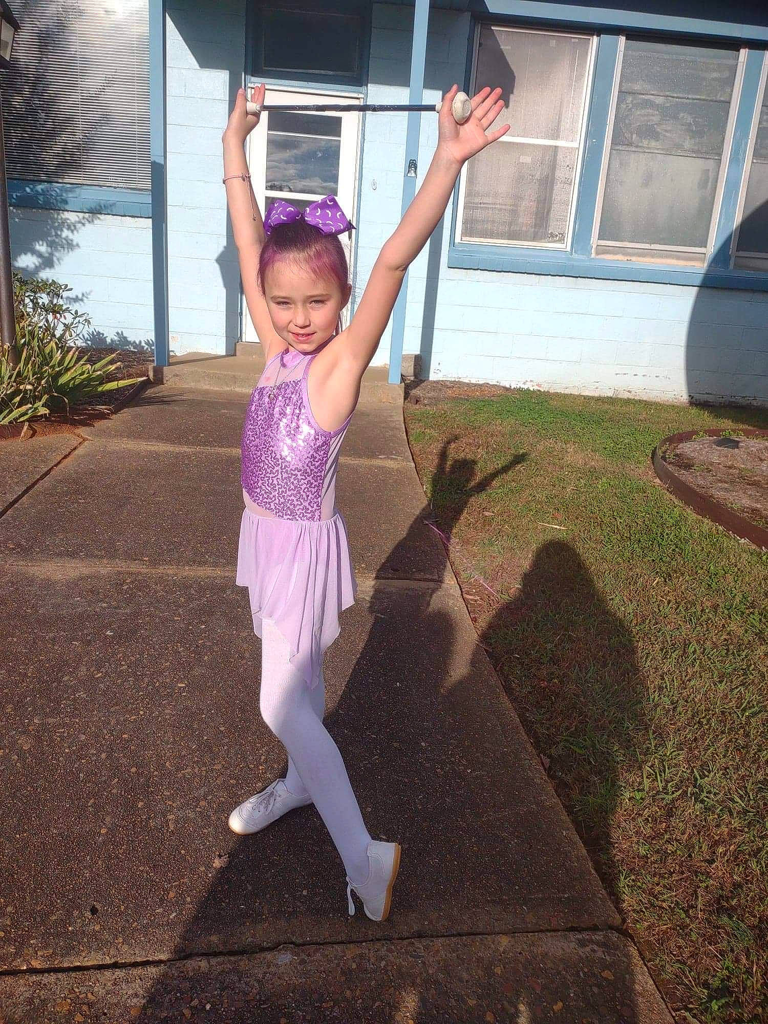 Chloe is registered to the contest to win money with this photo: arm, balance, barefoot, dance, grass, happy, human_body, human_leg, joy, leg, leisure, performing_arts, person, plant, sportswear, t_shirt, thigh, toddler, tree, trunk