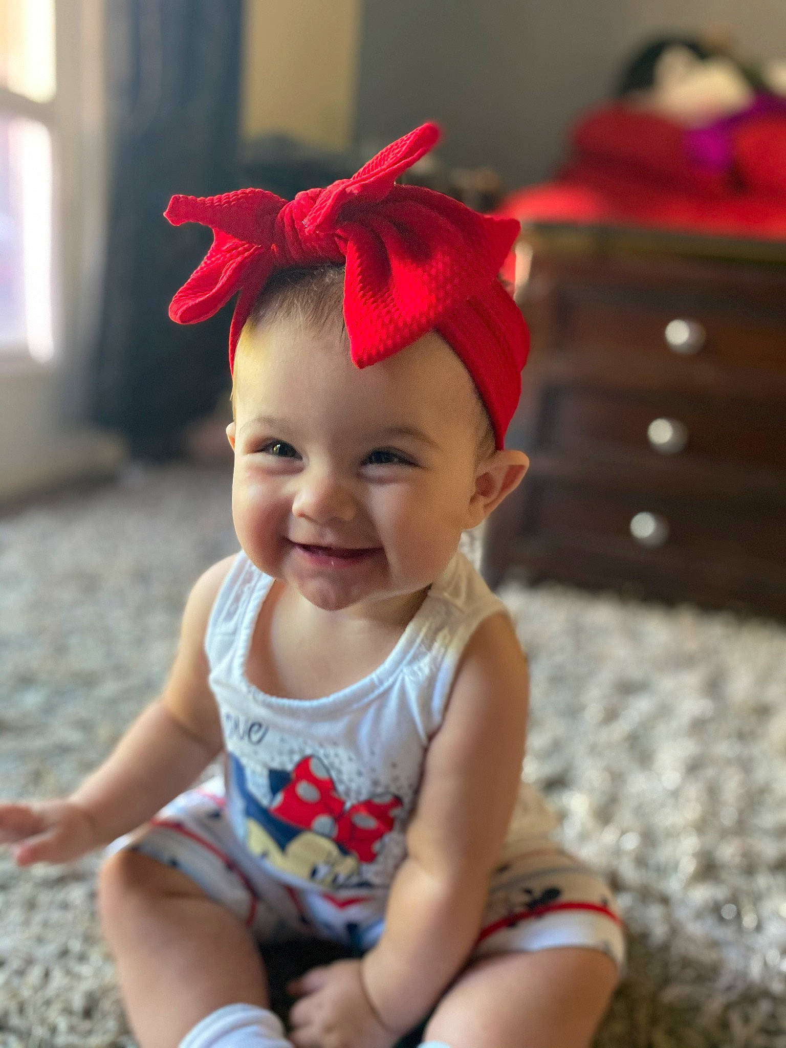 Leona is registered to the contest to win money with this photo: active_tank, baby, baby_laughing, baby_toddler_clothing, cabinetry, child, costume_accessory, hair_accessory, happy, headband, headgear, headpiece, joy, person, sleeveless_shirt, toddler