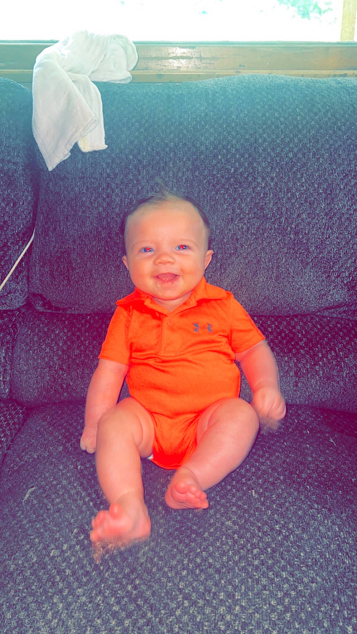 Kashton is registered to the contest to win money with this photo: baby, baby_toddler_clothing, barefoot, carmine, child, electric_blue, flooring, foot, fun, grass, happy, head, human_leg, joy, peach, person, pink, sitting, smile, thumb