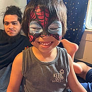 Ollie is registered to the contest to win money with this photo: beard, bedroom, casual, child, curtain, face_paint, foot, hair, happy, home, indoor, man, person, relaxing, smile, spiderman, stars, tank_top, vibes, window