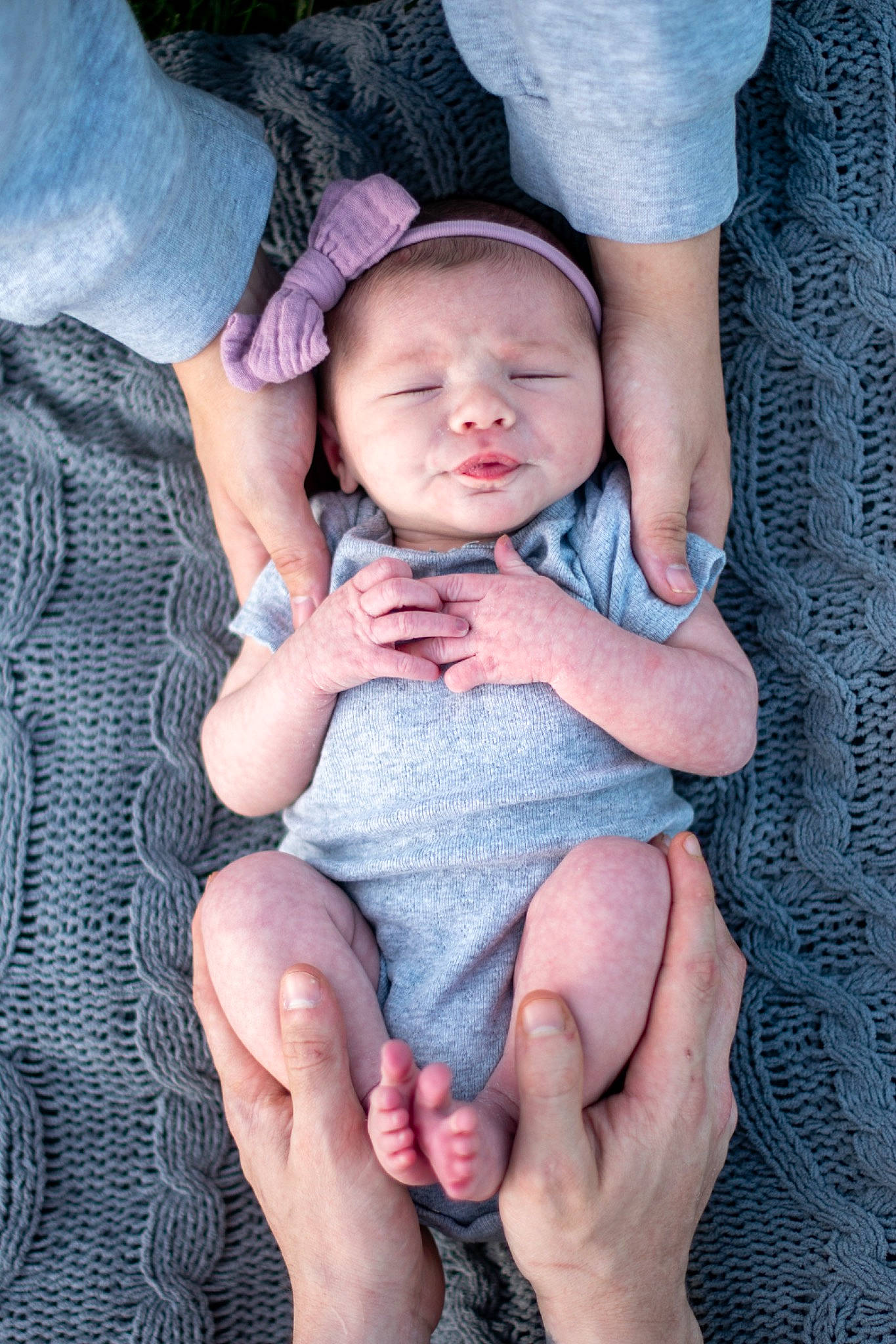 Averie joined the competition — help win amazing prizes! azure, baby, baby_toddler_clothing, blue, comfort, eye, face, finger, gesture, grass, hand, hat, human_body, lap, nail, person, purple, skin, thigh, thumb