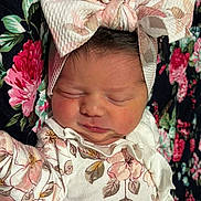Kenzie joined the competition — help win amazing prizes! newborn, baby, sleeping, headband, bow, floral_pattern, blanket, clothing, face, person, infant, cute, closeup, soft, resting, portrait, child, indoors, fabric, pink