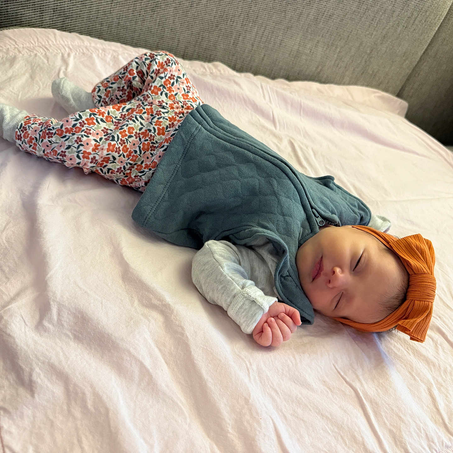Lina Rose joined the competition — help win amazing prizes! baby, blanket, child, couch, cozy, cute, floral_pants, headband, home, indoor, infant, orange_bow, peaceful, portrait, relaxing, resting, sleeping, soft_lighting, toddler, vest