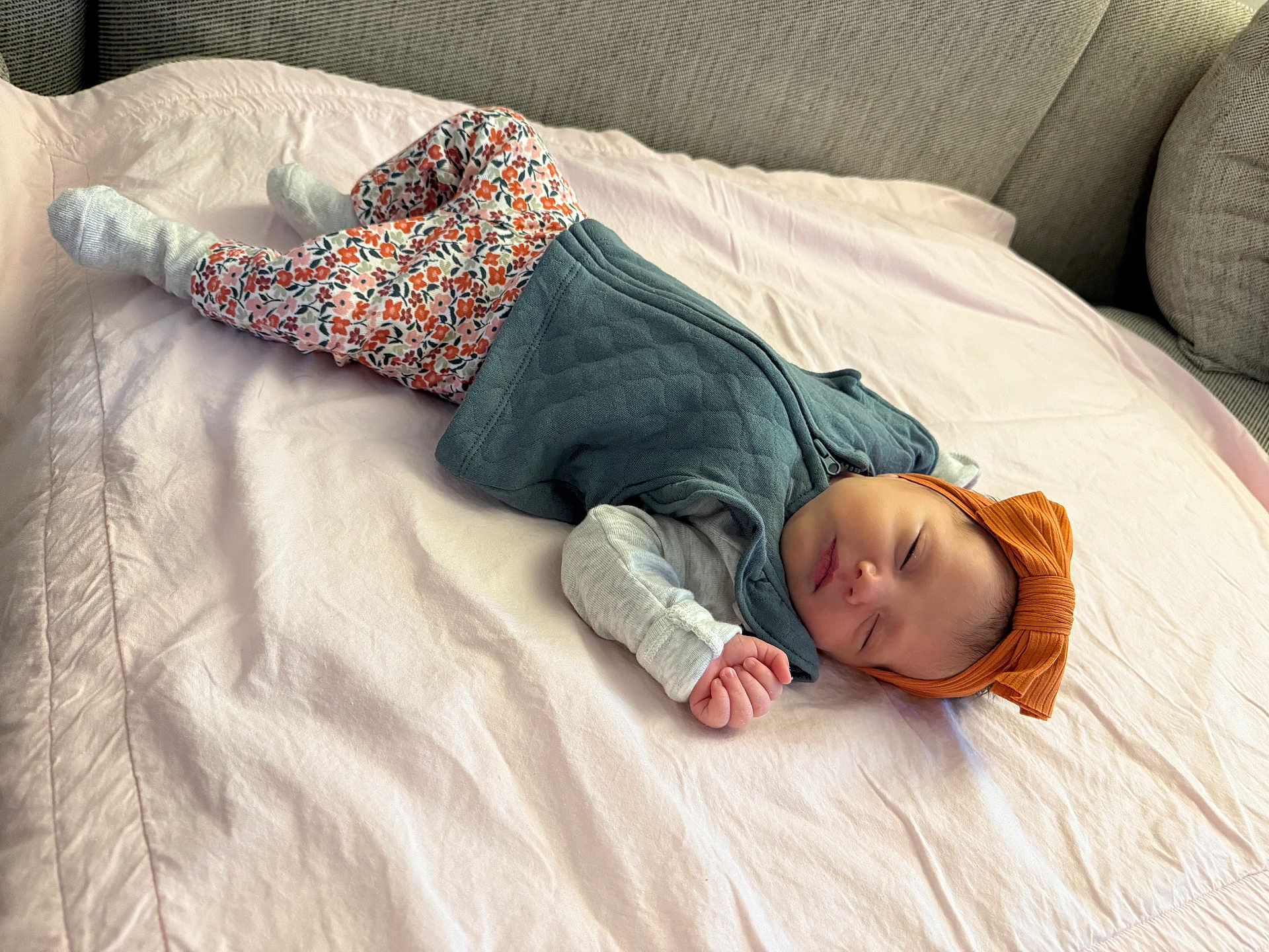 Lina Rose joined the competition — help win amazing prizes! baby, sleeping, floral_pants, headband, orange_bow, vest, blanket, couch, cozy, indoor, child, peaceful, resting, cute, infant, soft_lighting, home, portrait, relaxing, toddler