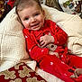 Lawton joined the competition — help win amazing prizes! baby, smiling, red_pajamas, reindeer, knit_blanket, holiday, christmas, gift_wrap, gingerbread_pattern, face, child, cozy, festive, indoors, cute, happy, person, portrait, seated, decor