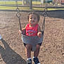 toddler, child, swing, playground, outdoor, curly_hair, red_shirt, sneakers, baby_swing, daylight, park, trees, blurred_background, summer, casual_clothing, expression, seat, play, person, young_child