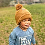 Silas joined the competition — help win amazing prizes! child, toddler, hat, pom_pom, sweatshirt, blue_clothing, outdoor, grass, field, smiling, face, person, nature, daylight, casual_wear, cute, young_child, portrait, happy, funny_message