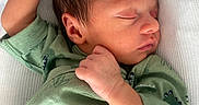 Ayden participe au concours pour gagner de l'argent avec cette photo : arm, baby, blanket, child, close_up, cozy, dinosaur_pattern, face, green_clothing, hair, hand, infant, newborn, onesie, pacifier, portrait, resting, skin, sleeping, soft_texture