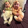Brynlee joined the competition — help win amazing prizes! baby, infant, two_babies, dress, headband, bow, sweater, tights, bed, pillow, smile, cute, indoors, child, sitting, footwear, portrait, happy, person, soft_lighting