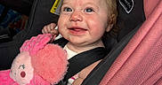 Brynlee is registered to the contest to win money with this photo: baby, car_seat, child, cute, pink, plush_toy, pigtails, smiling, infant, seatbelt, happy, portrait, indoors, child_protection, soft_toy, clothing, person, face, hair_accessory, car_interior