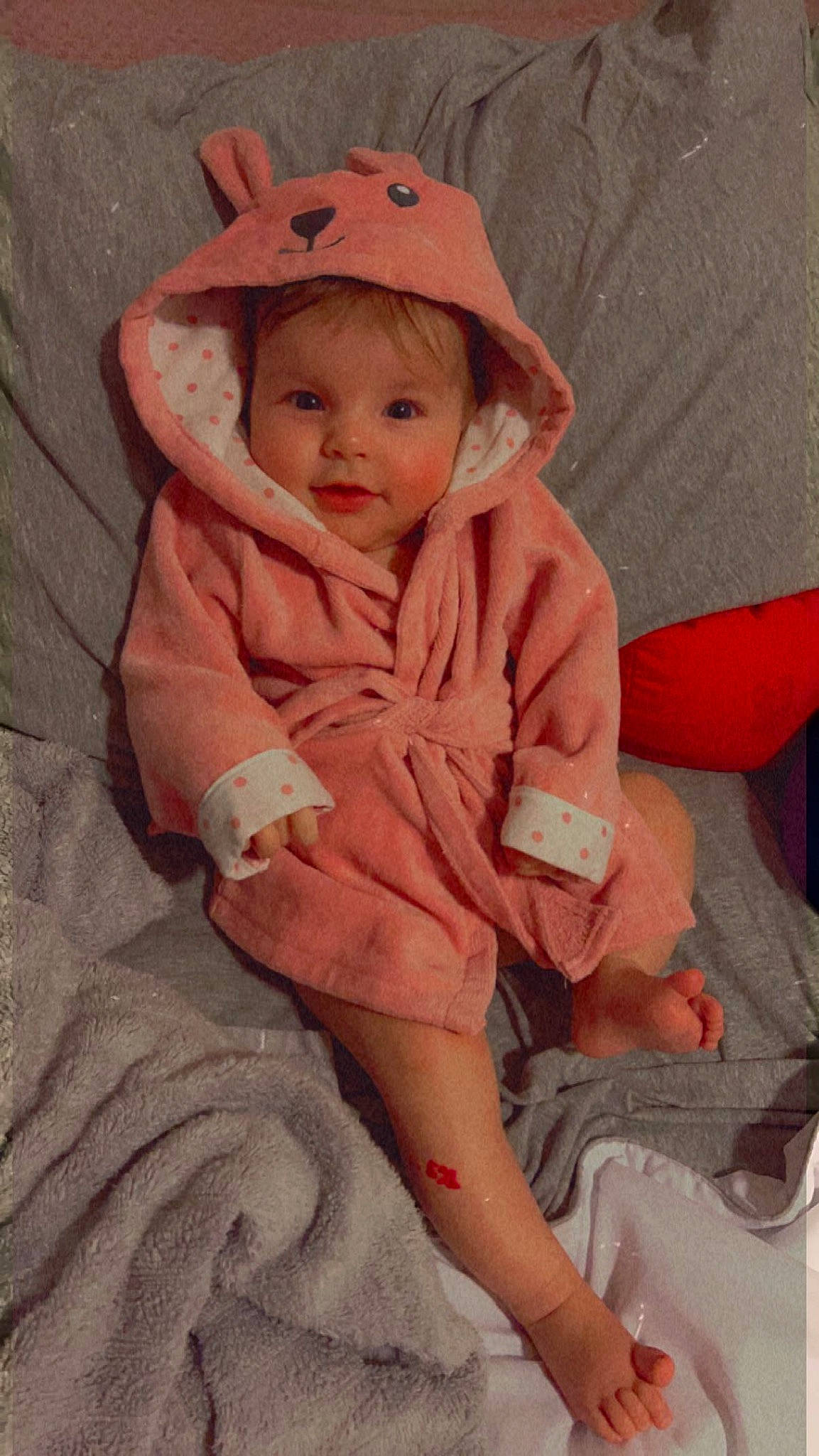 Lucía joined the competition — help win amazing prizes! baby, baby_toddler_clothing, cap, chair, comfort, dress, hair, human_leg, jacket, lap, lip, orange, peach, person, pink, sitting, sleeve, textile, thigh, thumb