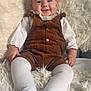 baby, infant, smiling, corduroy, overalls, white_tights, fluffy_rug, cozy, cute, child, portrait, indoor, happy, sitting, soft_texture, clothing, person, baby_girl, warm, relaxed