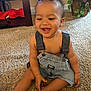 baby, child, toddler, denim, overalls, carpet, smile, happy, indoor, plant, toy, person, cute, sitting, skin, face, hair, clothing, foot, hand