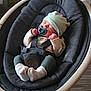 baby, pacifier, hat, baby_rocker, sleeping, infant, socks, clothing, indoor, wood_floor, comfort, child, seatbelt, modern_furniture, peaceful, cute, resting, baby_girl, baby_boy, cozy