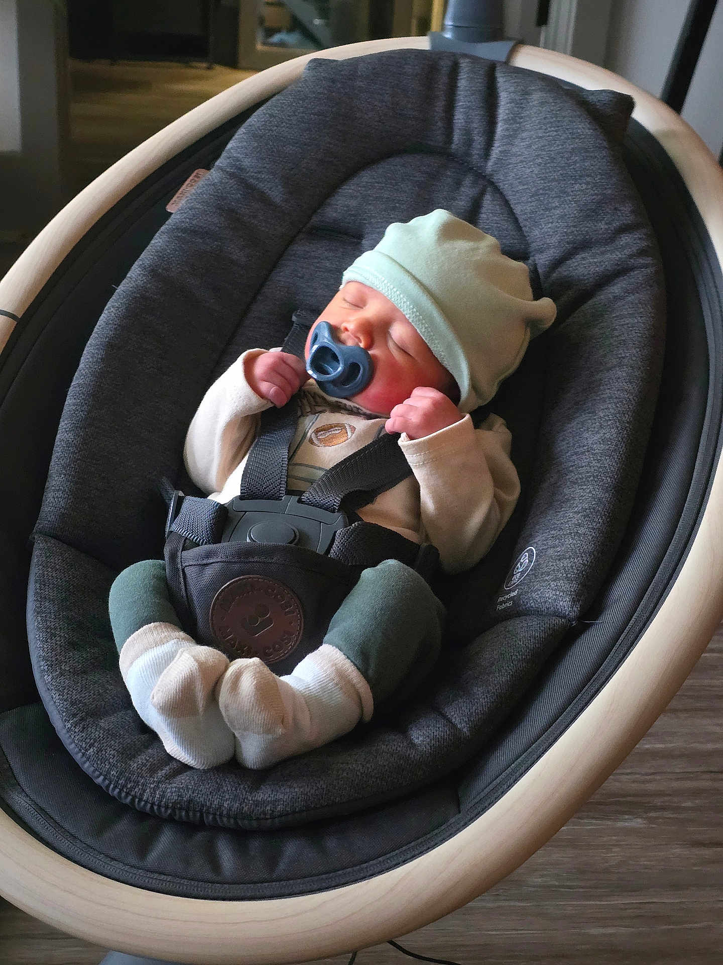 Braxton joined the competition — help win amazing prizes! baby, pacifier, hat, baby_rocker, sleeping, infant, socks, clothing, indoor, wood_floor, comfort, child, seatbelt, modern_furniture, peaceful, cute, resting, baby_girl, baby_boy, cozy