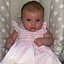 Marnie-Mai is registered to the contest to win money with this photo: baby, infant, child, pink_dress, baby_chair, star_pattern, face, eyes, hand, clothing, cushion, seat_belt, person, portrait, indoor, cute, young_child, sitting, looking_at_camera, skin