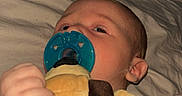 Evelyn is registered to the contest to win money with this photo: baby, bed, blanket, child, clothing, comfort, cozy, cute, face, hand, indoors, infant, lying_down, pacifier, plush_toy, resting, sleepy, soft_toy, toddler, young_child