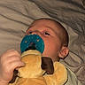 baby, bed, blanket, child, clothing, comfort, cozy, cute, face, hand, indoors, infant, lying_down, pacifier, plush_toy, resting, sleepy, soft_toy, toddler, young_child