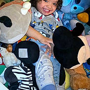 Kyrie joined the competition — help win amazing prizes! child, smiling, curly_hair, stuffed_animals, plush_toys, mickey_mouse, zebra_toy, toddler, happy, cozy, indoor, cuddly, playtime, cute, bedtime_clothes, soft_toys, colorful, joyful, portrait, young_kid