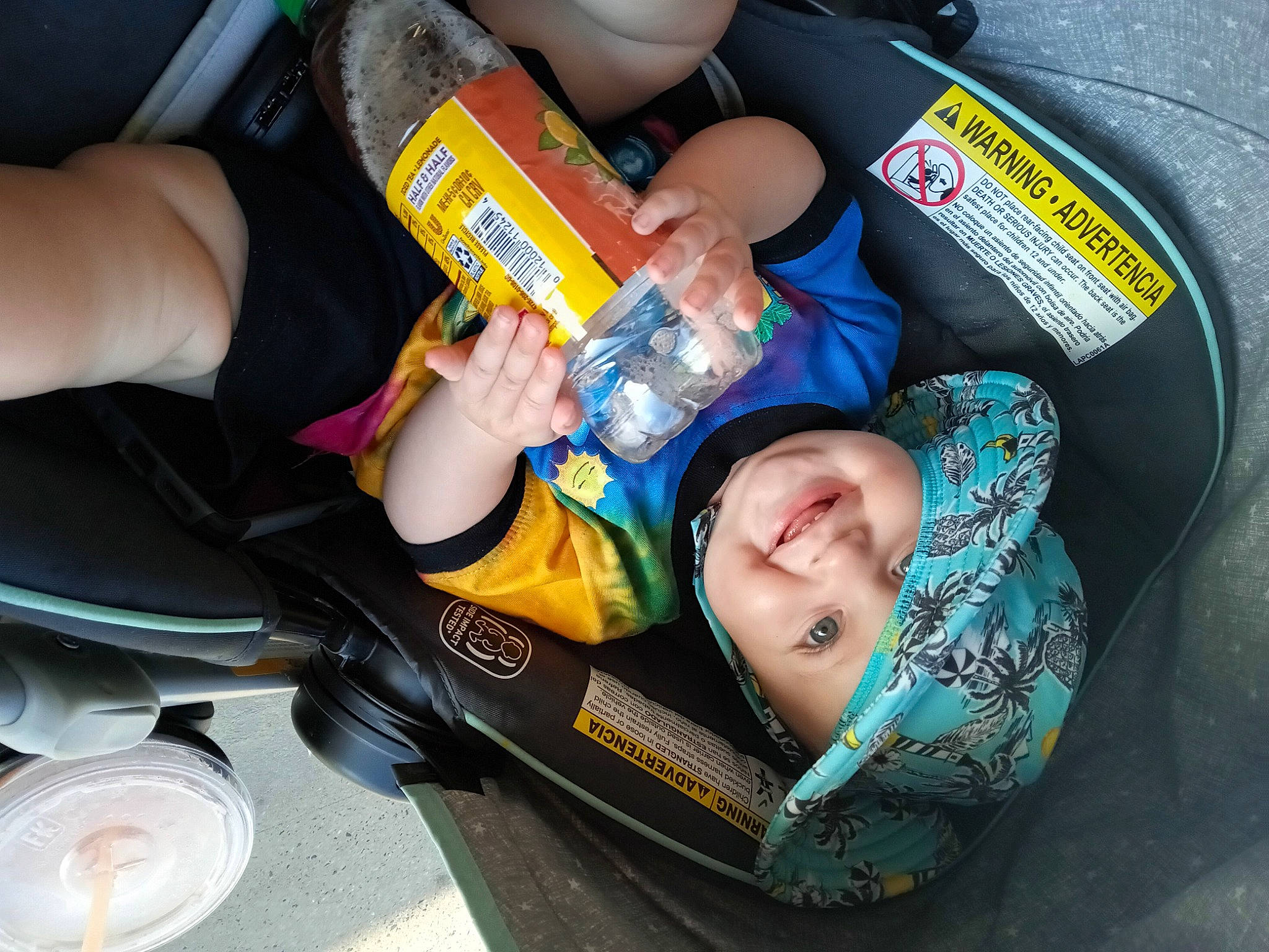 Genesis is registered to the contest to win money with this photo: arm, auto_part, baby, baby_products, baby_toddler_clothing, bottle, car_seat, child, drinkware, finger, food, fun, hand, headwear, nail, person, plastic_bottle, sitting, smile, thumb