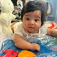 Raveena joined the competition — help win amazing prizes! baby, child, close_up, colorful, curly_hair, cute, expression, face, hands, hanging_toys, indoor, infant, playmat, playtime, portrait, soft_toys, teddy_bear, toys, white_clothing, young
