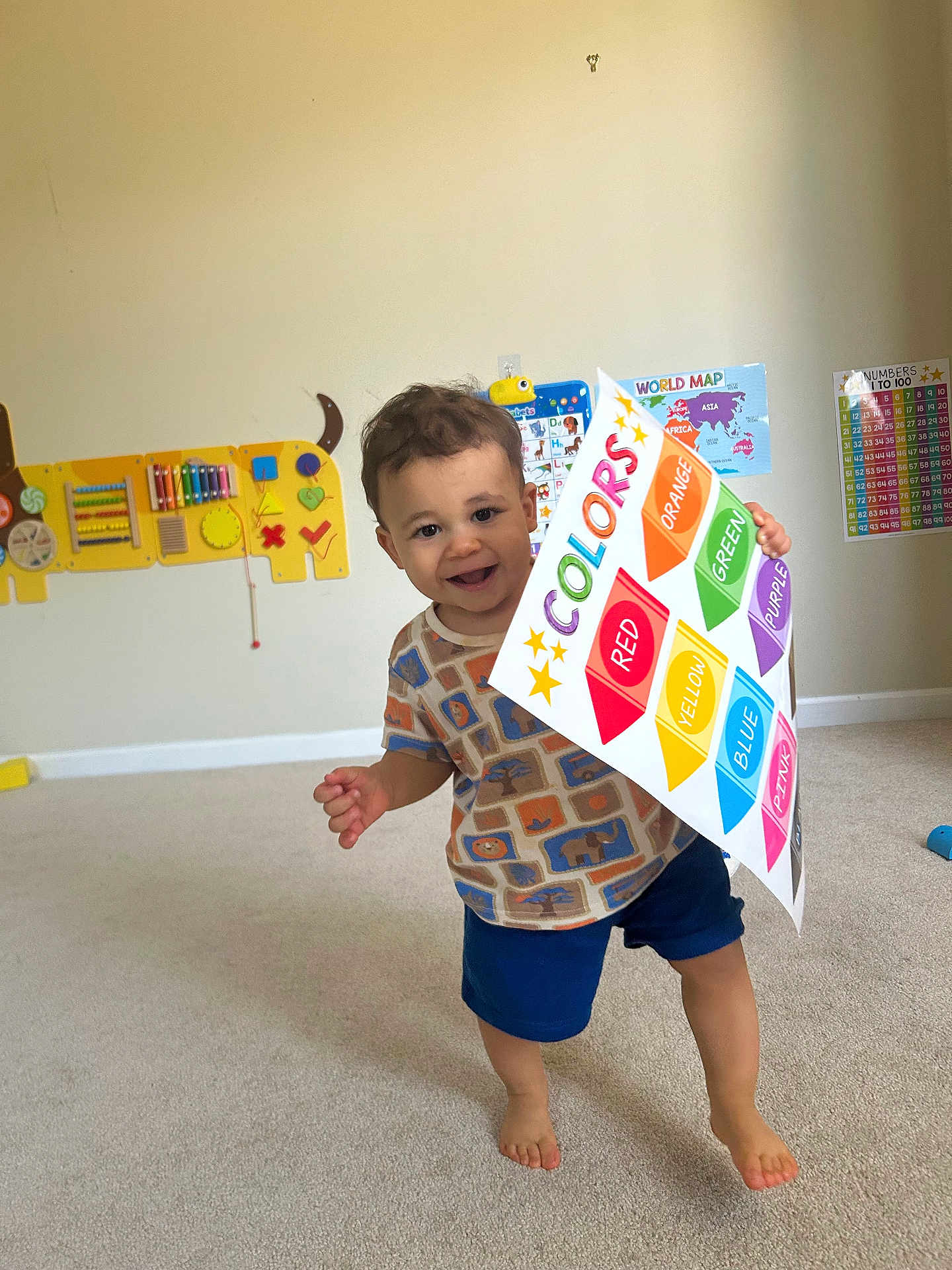 Langston joined the competition — help win amazing prizes! toddler, child, indoor, carpet, poster, colors, educational, learning, smiling, barefoot, shorts, shirt, playroom, map, numbers_chart, toy, happy, cute, boy, walking