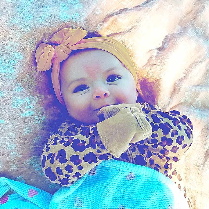 Wrenley is registered to the contest to win money with this photo: baby, bed, blanket, bonnet, cap, clothing, costume, dress, face, furniture, glove, happy, hat, head, newborn, person, photography, portrait, quilt, smile
