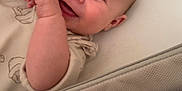 George joined the competition — help win amazing prizes! baby, smiling, infant, face, hands, lying_down, cozy, clothing, bed, bedding, neutral_colors, happy, cute, closeup, skin, eyes, young_child, soft_texture, indoors, portrait
