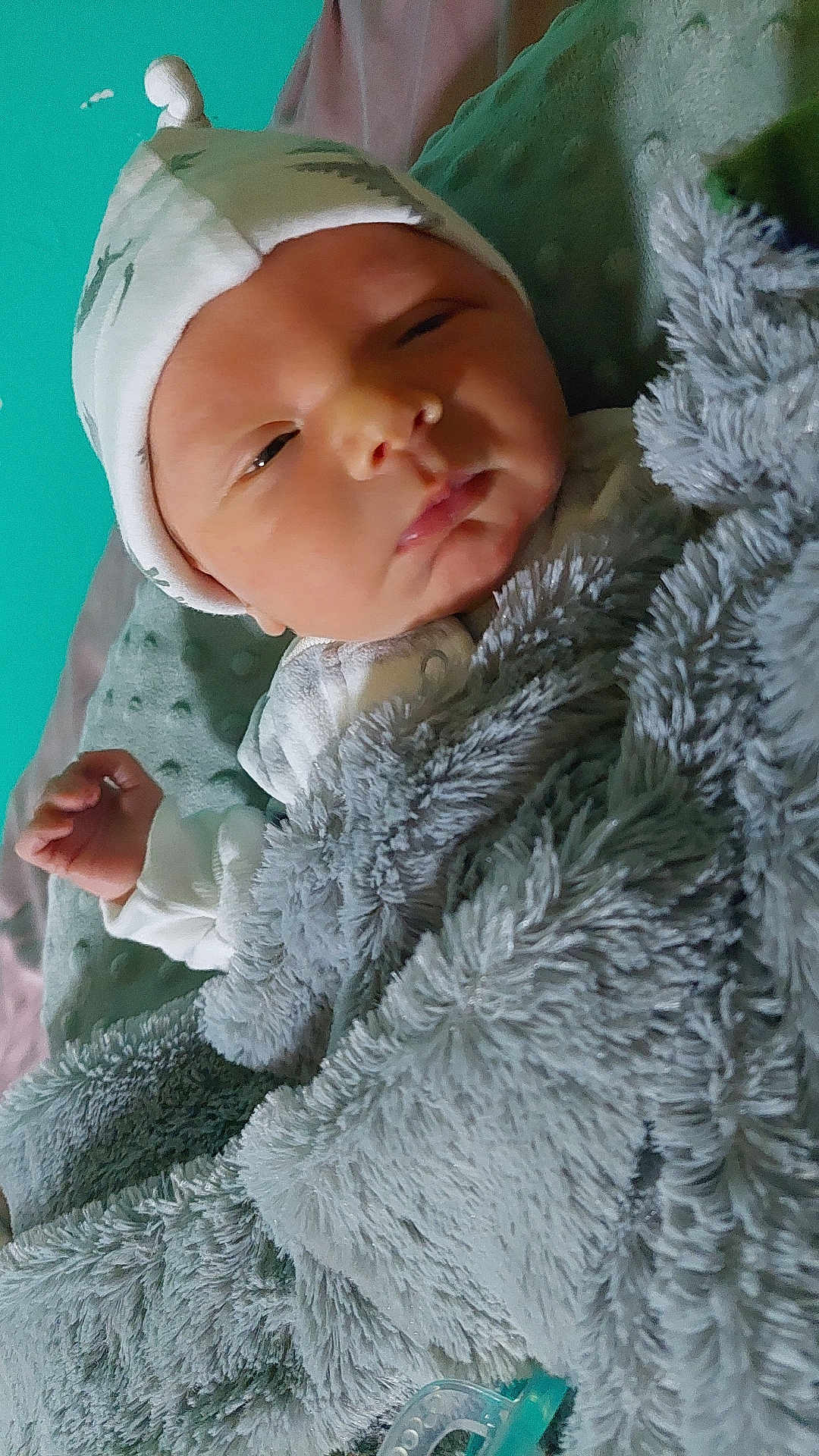 Lucas is registered to the contest to win money with this photo: newborn, baby, blanket, hat, sleepy, infant, soft_texture, cozy, wrapped, pacifier, bed, cute, face, hand, resting, indoors, child, warm, comfort, portrait