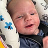 baby, infant, child, smiling, happy, face, portrait, sitting, harness, seat, patterned_fabric, blue_clothing, indoor, close_up, eyes, mouth, cheeks, baby_gear, photography, safe