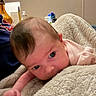 Stevie is registered to the contest to win money with this photo: infant, baby, blanket, soft, indoor, person, face, head, curious, lying_down, skin, young_child, cozy, warm, human, expression, pink_clothing, texture, closeup, comfort