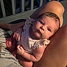 Stevie joined the competition — help win amazing prizes! baby, infant, person, legs, lap, clothing, striped_shirt, skin, outdoor, railing, night, curious, looking_up, holding, human, sitting, young_child, casual, relaxed, portrait
