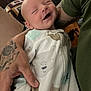 Maverick is registered to the contest to win money with this photo: baby, child, smiling, happy, person, infant, onesie, bear_print, tattoo, arm, hand, closeup, indoor, fabric, clothing, cute, sleepy, care, love, comfort