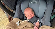Tyler Braden joined the competition — help win amazing prizes! baby, newborn, car_seat, graco, blanket, pacifier, wooden_floor, infant, sleeping, child, person, indoor, cozy, knitted_blanket, baby_gear, resting, cute, small, straps, comfort