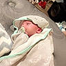Tyler Braden joined the competition — help win amazing prizes! baby, swaddle, pacifier, bed, blanket, hooded_towel, infant, face, sleepy, indoor, footwear, dresser, carpet, furniture, room, person, cozy, sleep, child, newborn