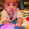baby, child, infant, play_mat, toy, glowing_toy, colorful, indoor, closeup, hands, face, expression, curious, crawling, soft_lighting, skin, clothing, floor, cute, young