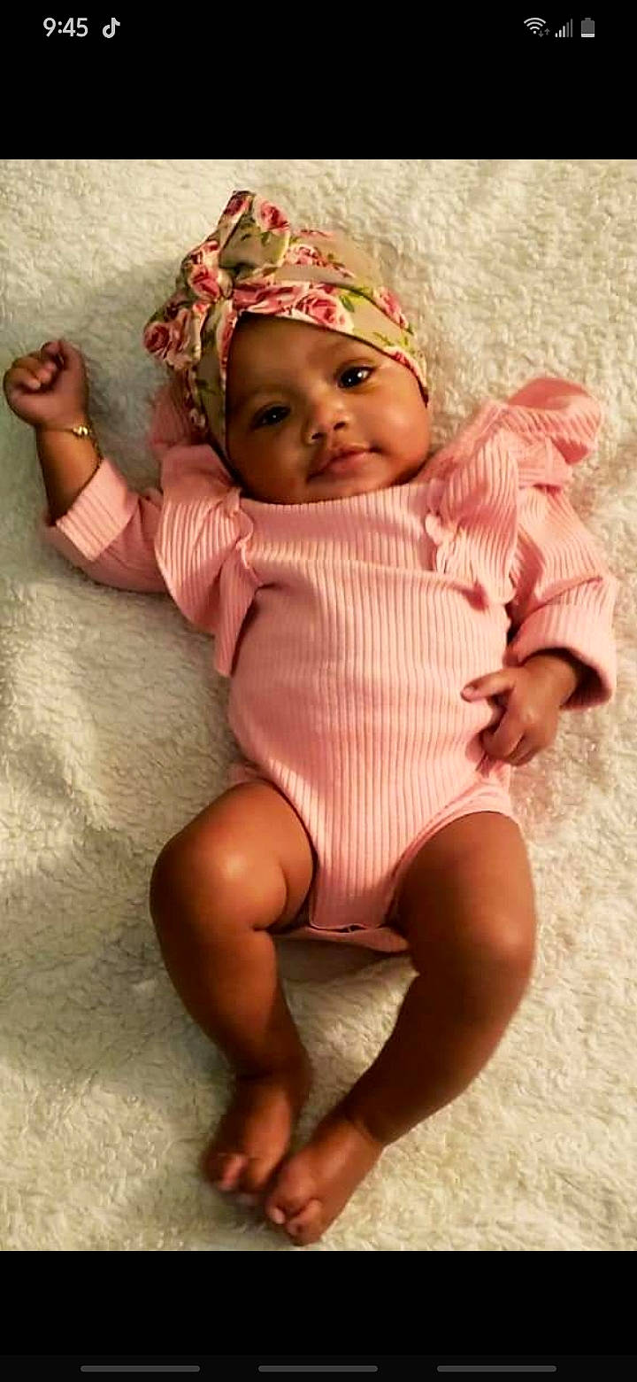 Zoedior is registered to the contest to win money with this photo: baby, baby_toddler_clothing, comfort, eye, face, finger, foot, happy, head, headgear, headwear, human_leg, knee, lip, mouth, nail, person, pink, skin, thigh