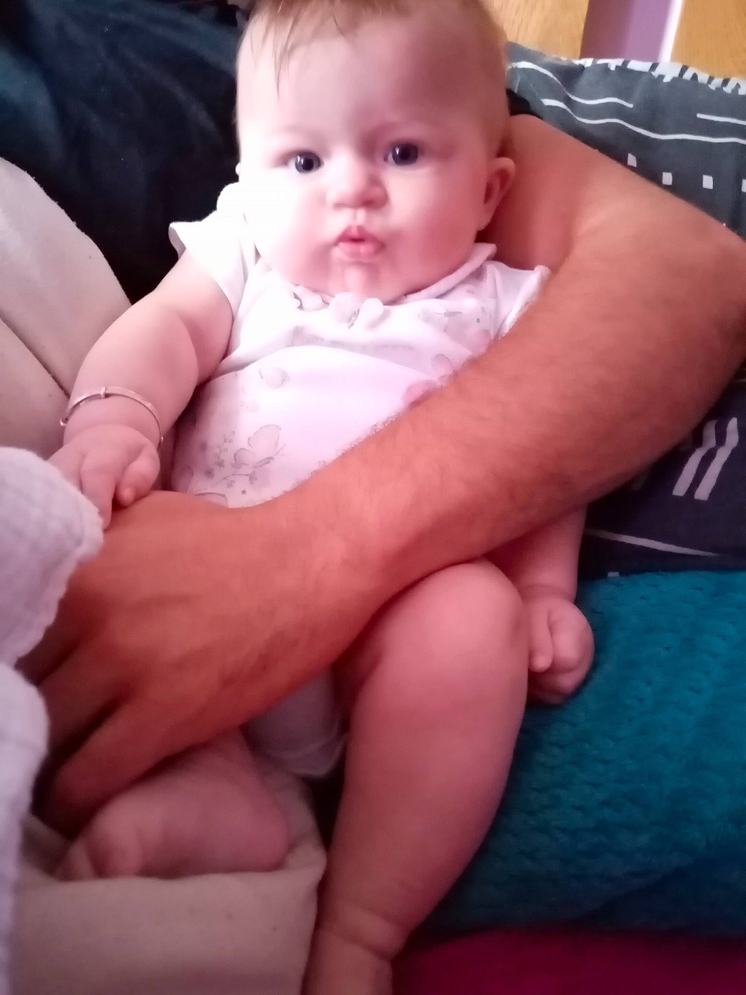 Macey is registered to the contest to win money with this photo: arm, baby, cheek, child, eye, face, finger, hand, head, leg, lip, mouth, muscle, nose, person, sitting, skin, smile, thigh, thumb