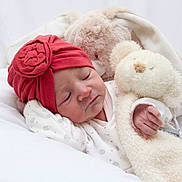 Shelsy participe au concours pour gagner de l'argent avec cette photo : baby, child, clothing, cozy, cute, face, flower, hand, indoors, infant, newborn, peaceful, plush_toy, portrait, red_hat, resting, sleeping, soft_texture, teddy_bear, white_background