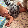 Connor is registered to the contest to win money with this photo: baby, sleeping, blanket, pillow, bed, floral_bedsheet, infant, peaceful, soft, indoors, child, cozy, resting, cute, skin, hand, foot, newborn, comfort, nap