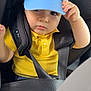 baby, blue_cap, car_interior, car_seat, casual, child, child_safety, clothing, cute, denim_shorts, face, hand, hat, portrait, safety, seatbelt, summer, toddler, yellow_shirt, young_child