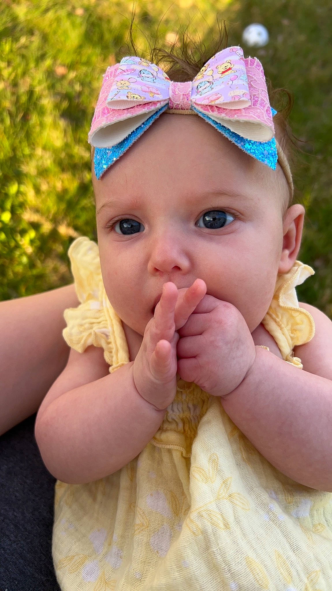 Felicity is registered to the contest to win money with this photo: baby, baby_toddler_clothing, cap, child, eye, fashion_accessory, finger, fun, gesture, grass, happy, headband, headpiece, headwear, jewellery, lip, nail, person, pink, skin
