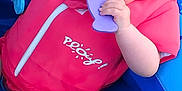 Ella-May is registered to the contest to win money with this photo: toddler, child, life_jacket, inflatable_pool, toy, purple_toy, blue_pool, pink_clothing, summer, outdoor, grass, water_toys, cute, chewing, playtime, baby, infant, fun, safety, colorful